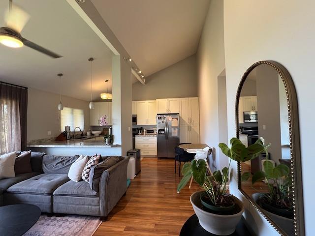 15 Kulanihakoi St Unit 9E, Kihei, HI 96753 - living area featuring high vaulted ceiling, wood finished floors, and a ceiling fan