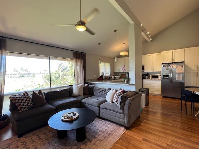 15 Kulanihakoi St Unit 9E, Kihei, HI 96753 - living room featuring high vaulted ceiling, light wood-style flooring, and a ceiling fan