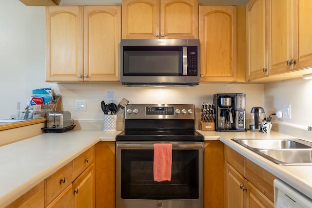 kitchen with sink, stainless steel appliances, and light brown cabinets