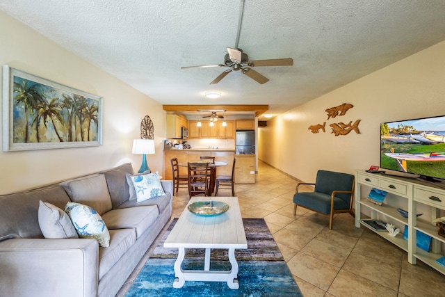 tiled living room with a textured ceiling and ceiling fan