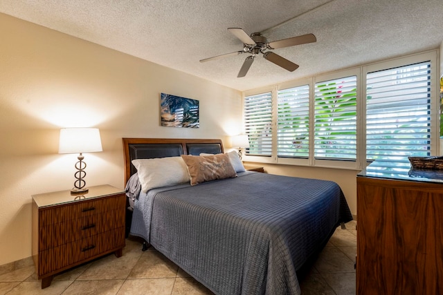 tiled bedroom featuring a textured ceiling and ceiling fan