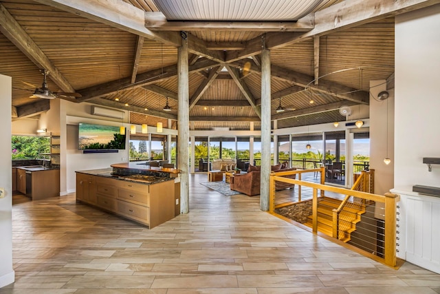 kitchen featuring beam ceiling, ceiling fan, and wood ceiling