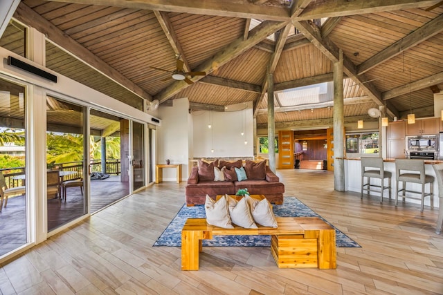 living room featuring beamed ceiling, light hardwood / wood-style floors, wooden ceiling, and high vaulted ceiling