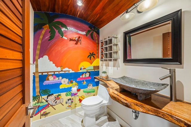 bathroom featuring hardwood / wood-style floors, toilet, and wooden ceiling