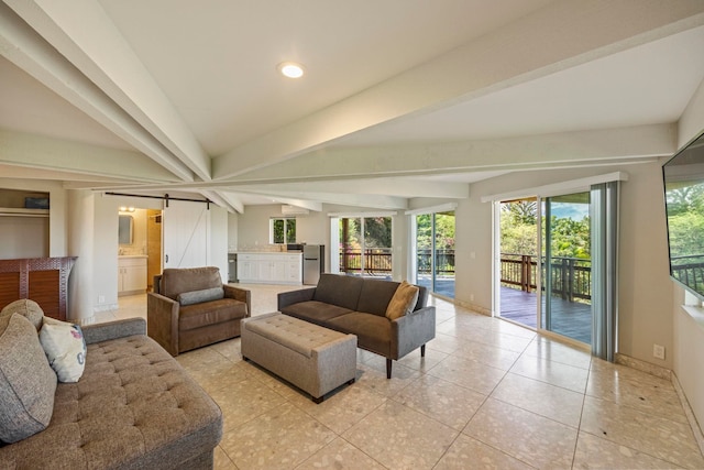 tiled living room with vaulted ceiling with beams and a barn door