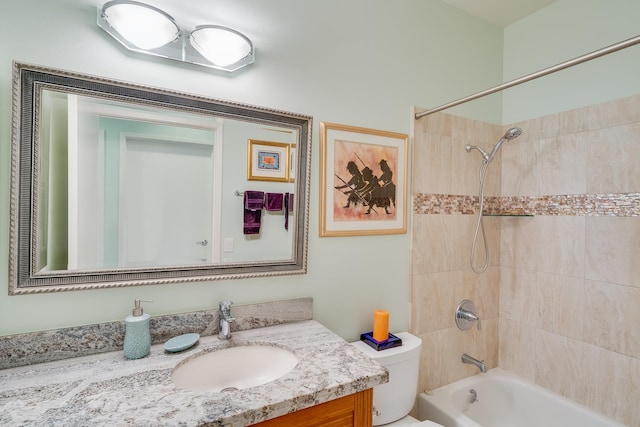 full bathroom featuring vanity, toilet, and tiled shower / bath