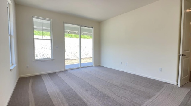 carpeted spare room with baseboards