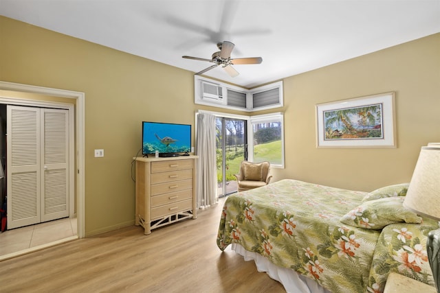 bedroom with ceiling fan, light hardwood / wood-style floors, and a closet