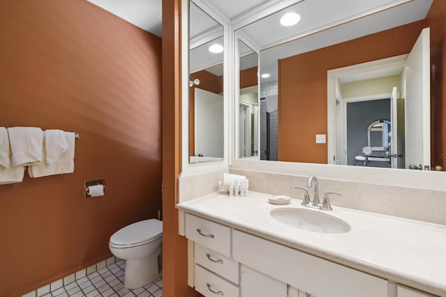 bathroom featuring toilet, tile patterned flooring, and vanity