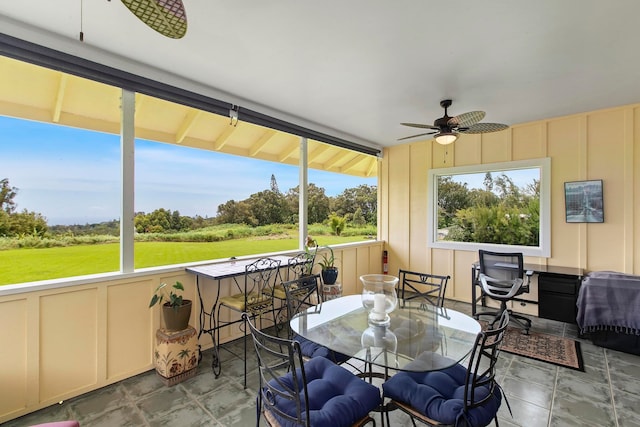 sunroom / solarium with ceiling fan and a healthy amount of sunlight