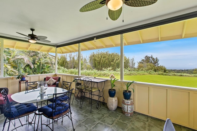 sunroom / solarium featuring ceiling fan