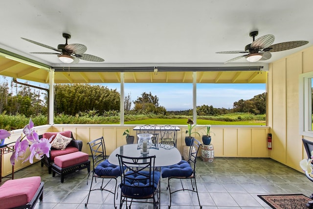 sunroom / solarium featuring ceiling fan