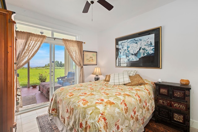 bedroom with access to outside, light tile patterned floors, and ceiling fan