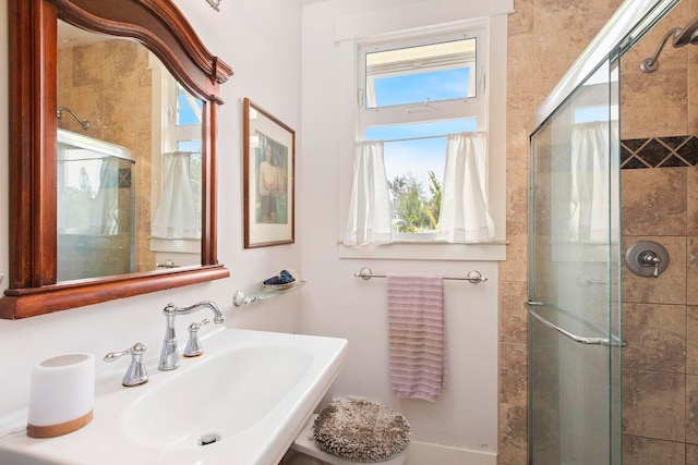 bathroom featuring sink and an enclosed shower