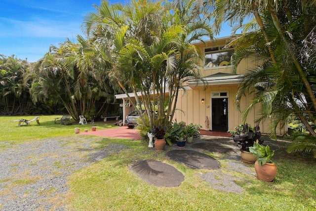 exterior space featuring a front lawn and a carport