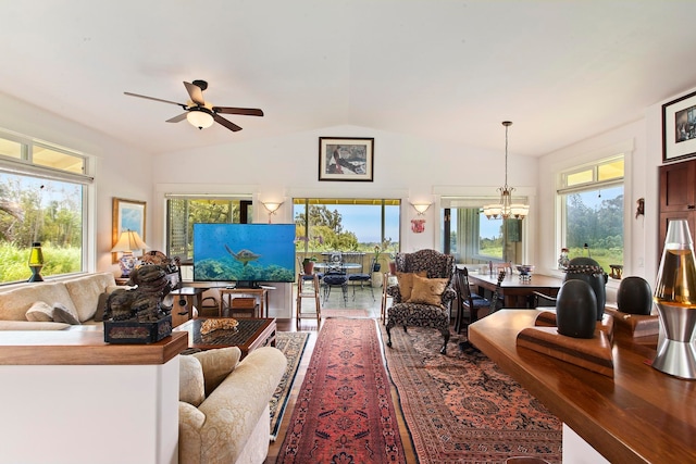 living room with wood-type flooring, ceiling fan with notable chandelier, lofted ceiling, and a healthy amount of sunlight