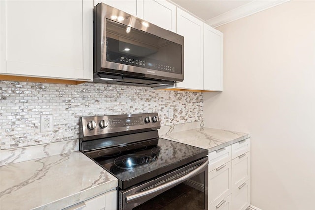 kitchen with backsplash, stainless steel appliances, and white cabinetry