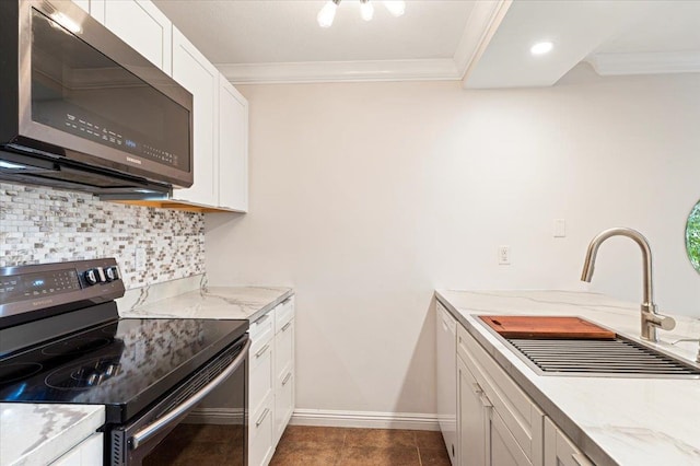 kitchen featuring backsplash, range with electric stovetop, dark tile flooring, white cabinets, and sink