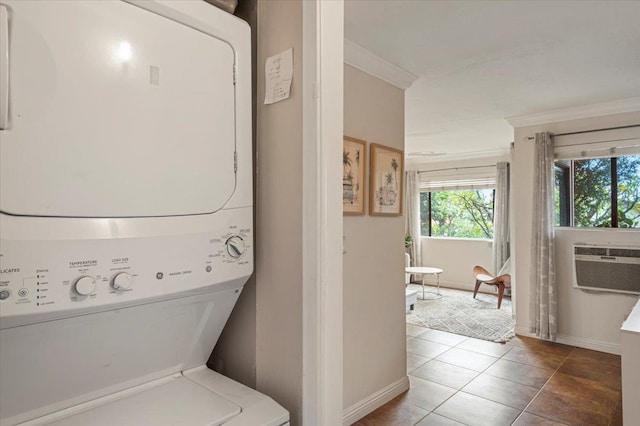 washroom featuring ornamental molding, stacked washer / dryer, and tile floors