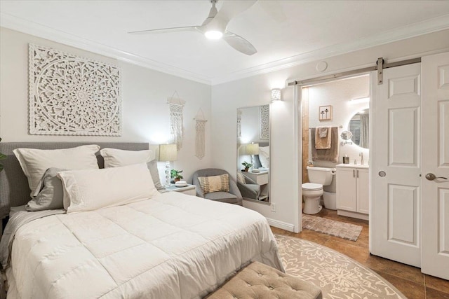 bedroom featuring ensuite bathroom, a barn door, ceiling fan, tile floors, and ornamental molding