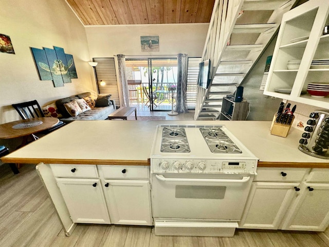 kitchen featuring white range, light hardwood / wood-style floors, white cabinetry, and wooden ceiling