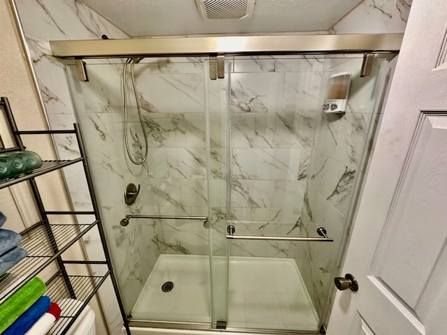 bathroom featuring a shower with shower door