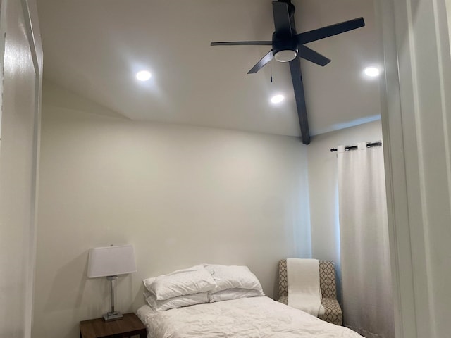 bedroom with ceiling fan and vaulted ceiling with beams