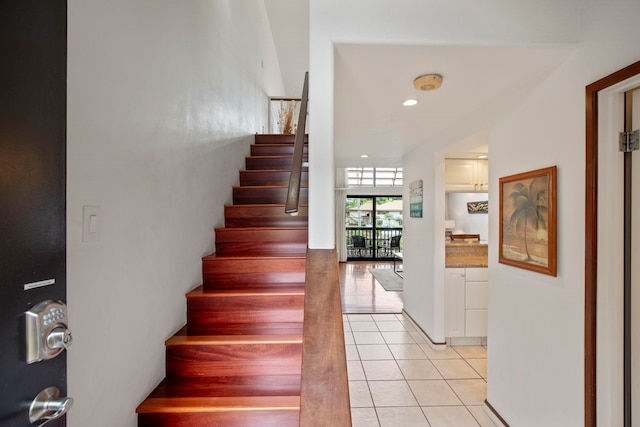stairs featuring tile patterned flooring