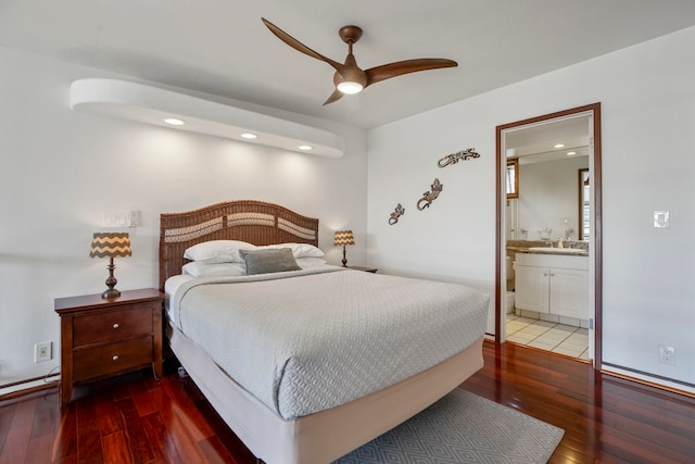 bedroom with a sink, a ceiling fan, hardwood / wood-style floors, and ensuite bathroom