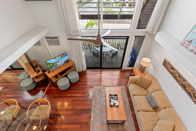 interior space with a wall mounted AC and wood finished floors