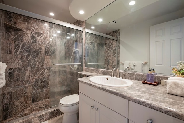 full bath featuring vanity, toilet, recessed lighting, and a stall shower