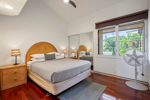 bedroom featuring wood finished floors, a closet, ceiling fan, baseboards, and high vaulted ceiling