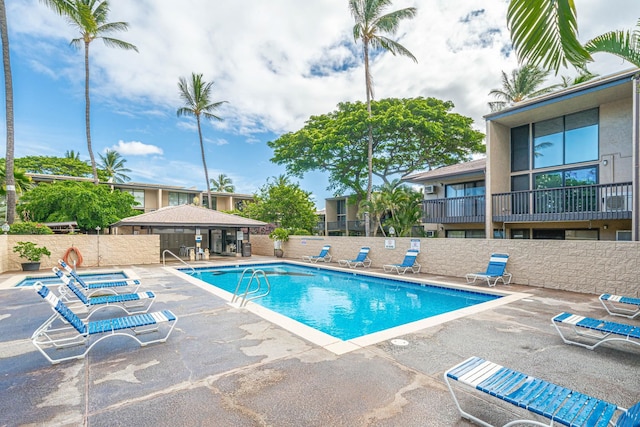 community pool featuring fence and a patio area