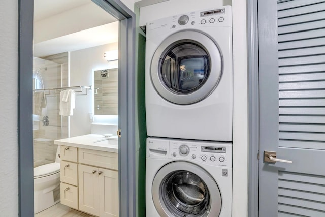 laundry room featuring sink and stacked washer and dryer