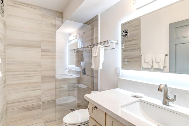 bathroom with toilet, vanity, and an enclosed shower