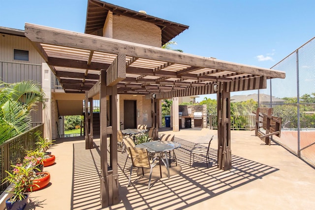 view of patio / terrace with an outdoor kitchen and a pergola