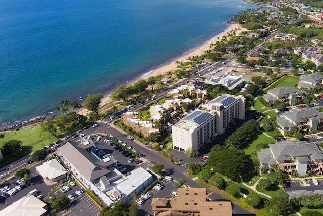 birds eye view of property featuring a water view and a beach view