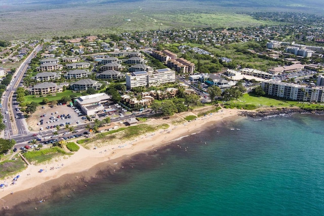 birds eye view of property with a water view and a view of the beach