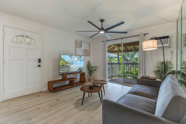480 Kenolio Rd Unit 24-202, Kihei, HI 96753 - living room featuring an AC wall unit, light wood-style flooring, and ceiling fan