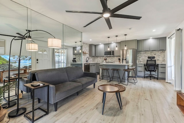 480 Kenolio Rd Unit 24-202, Kihei, HI 96753 - living area featuring plenty of natural light, a ceiling fan, and light wood-style floors