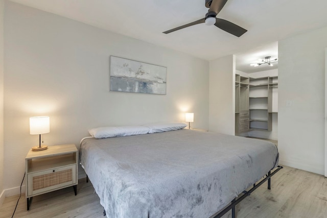 480 Kenolio Rd Unit 24-202, Kihei, HI 96753 - bedroom featuring wood finished floors, a spacious closet, ceiling fan, and a closet