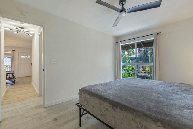 480 Kenolio Rd Unit 24-202, Kihei, HI 96753 - bedroom with a chandelier, light wood finished floors, baseboards, and ceiling fan