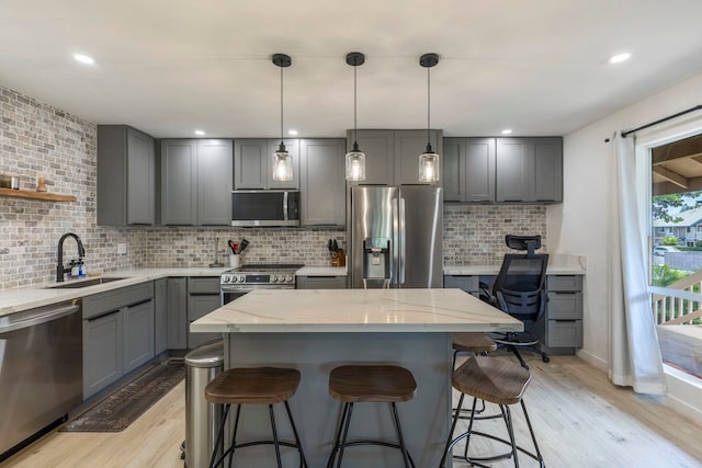 480 Kenolio Rd Unit 24-202, Kihei, HI 96753 - kitchen with stainless steel appliances, a sink, gray cabinets, light wood-type flooring, and recessed lighting