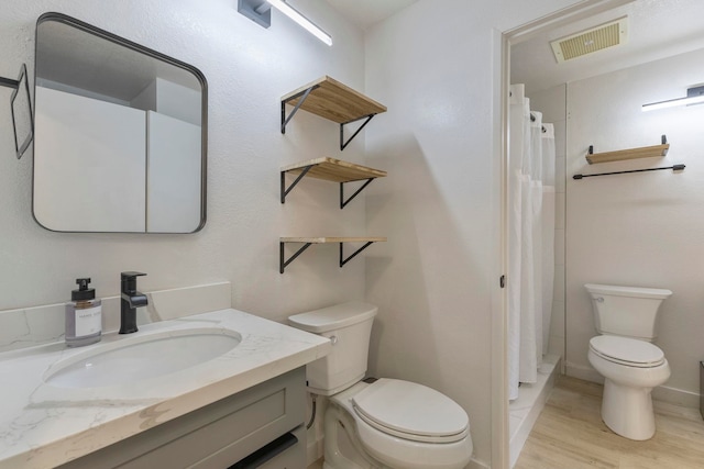 480 Kenolio Rd Unit 24-202, Kihei, HI 96753 - full bathroom featuring toilet, vanity, wood finished floors, and curtained shower