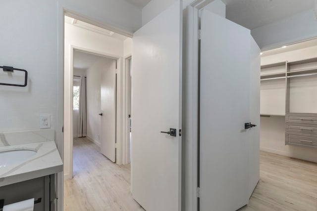 480 Kenolio Rd Unit 24-202, Kihei, HI 96753 - bathroom featuring wood finished floors, vanity, and baseboards