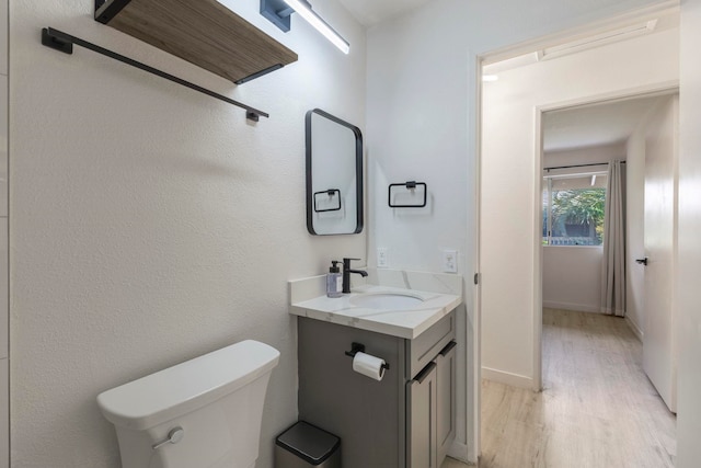 480 Kenolio Rd Unit 24-202, Kihei, HI 96753 - half bathroom featuring wood finished floors, vanity, and toilet