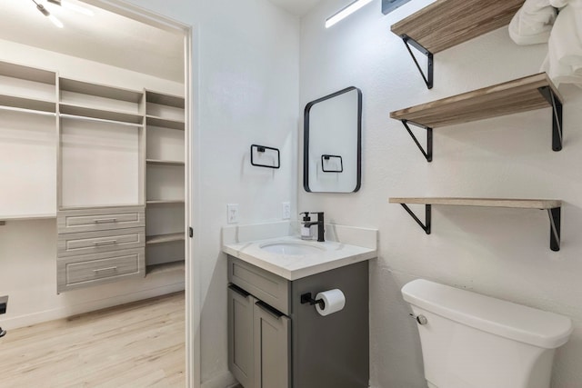 480 Kenolio Rd Unit 24-202, Kihei, HI 96753 - bathroom with vanity, wood finished floors, toilet, and baseboards