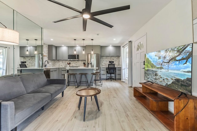 480 Kenolio Rd Unit 24-202, Kihei, HI 96753 - living room with light wood finished floors, a ceiling fan, and recessed lighting