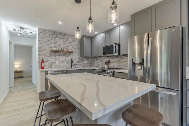 480 Kenolio Rd Unit 24-202, Kihei, HI 96753 - kitchen with appliances with stainless steel finishes, gray cabinets, tasteful backsplash, a sink, and open shelves