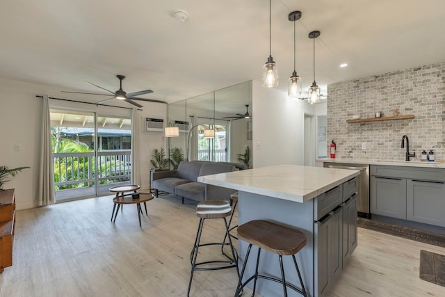 480 Kenolio Rd Unit 24-202, Kihei, HI 96753 - kitchen with ceiling fan, a sink, gray cabinetry, and light wood-type flooring